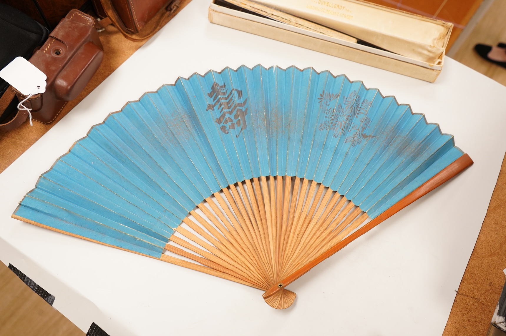 A gold mounted lace and hand painted fan and three others to include a lacquered example, one cased